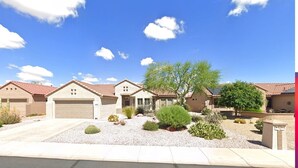 A residential area with houses featuring red-tiled roofs and beige stucco walls. - Stylish 3 Bedroom Sun City Grand Retreat w/ Resort Access in Surprise, Arizona (Surprise)