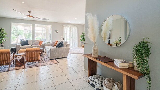 A modern living room with a sofa set, a wooden coffee table, and a console table with books and plants. - Stylish 3 Bedroom Sun City Grand Retreat w/ Resort Access in Surprise, Arizona (Surprise)