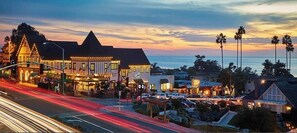 A coastal town at dusk with illuminated buildings, a road with light trails, and palm trees. - Ideal Location~Amazing Ocean & Sunset Views~Outdoor Living Spaces~Chef’s Kitchen (Del Mar)