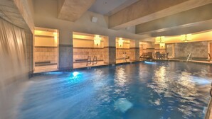 An indoor swimming pool with clear water, tiled walls, and a ceiling with exposed beams. - Ski in/out at Westgate, studio, Resort amenities, Mutiple Pools, Onsite Spa and Restaurant 4802B (Park City)