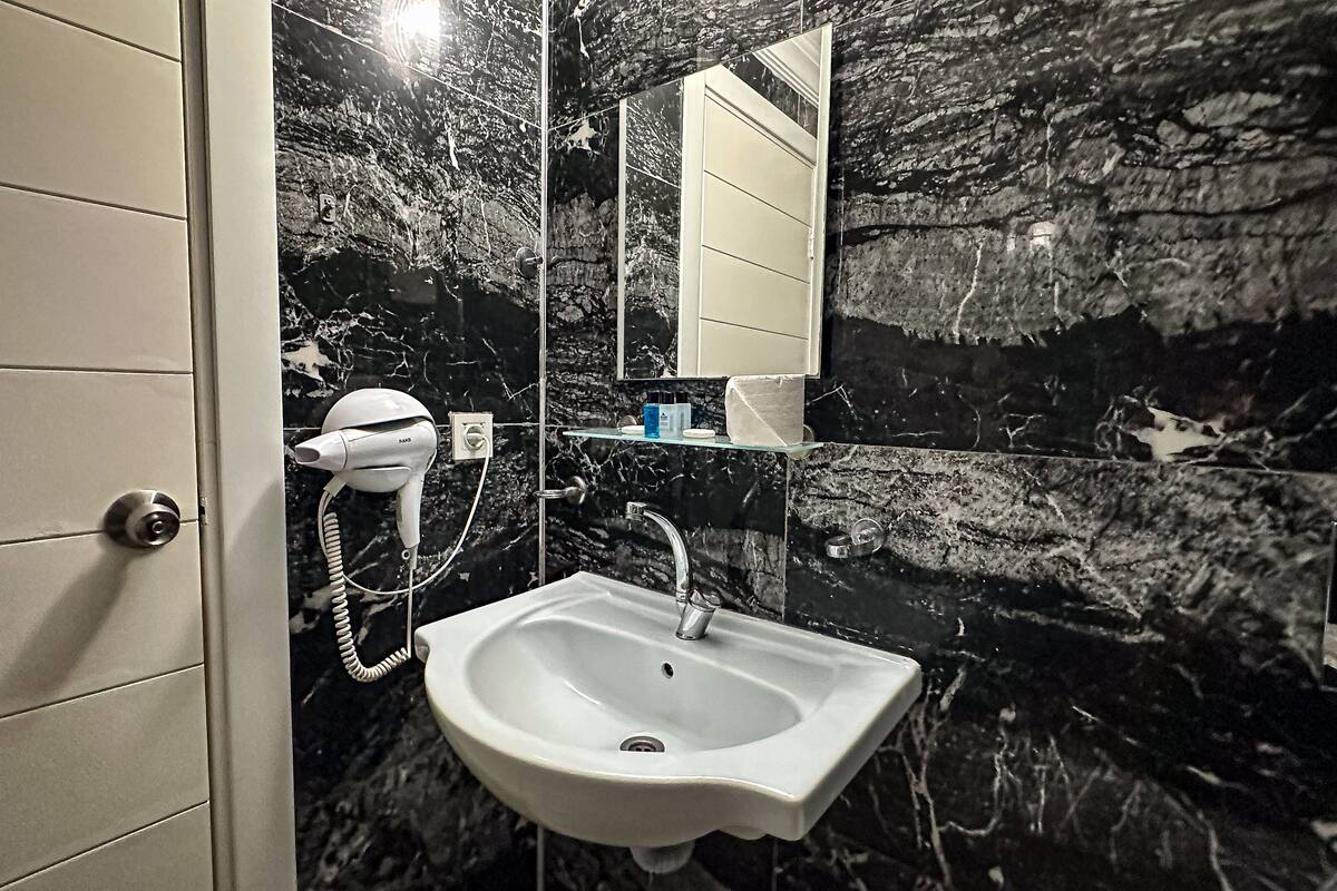 shower, hair dryer, slippers, towels