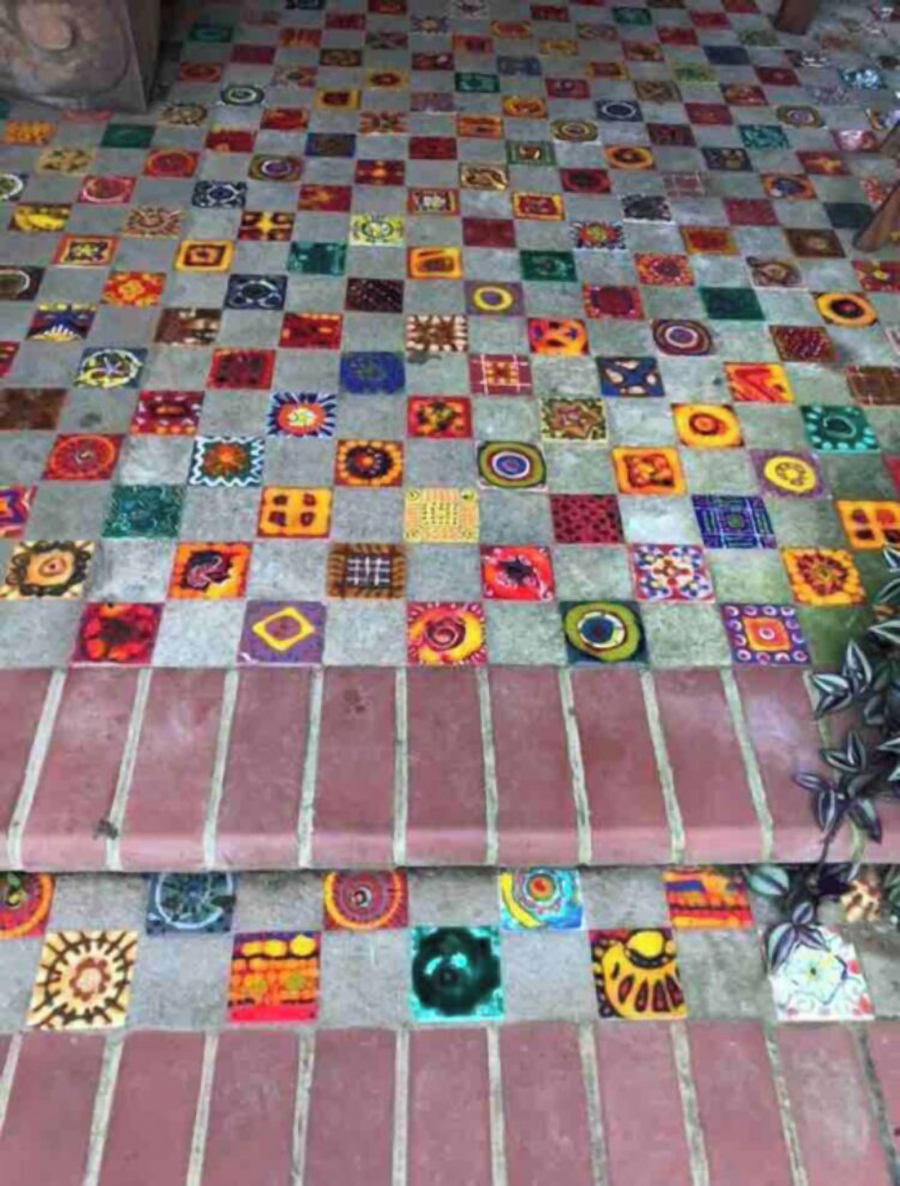 A floor with a mosaic pattern of variously colored tiles.