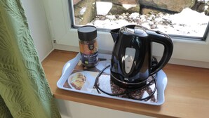 A coffee maker and a coffee jar on a tray by a window with a view of rocks and snow. - Room with private bathroom in detached house (Königsfeld im Schwarzwald)