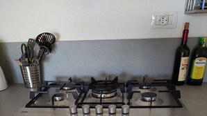 A kitchen with a gas stove, oven, and a stainless steel range hood. - Sea view, Pleasant house in the heart of olive groves in the countryside (Murta Maria)