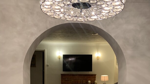 A living room with a fireplace, a flat-screen TV, and a chandelier. - Beautiful big Independent Furnished Bungalow (High Wycombe)