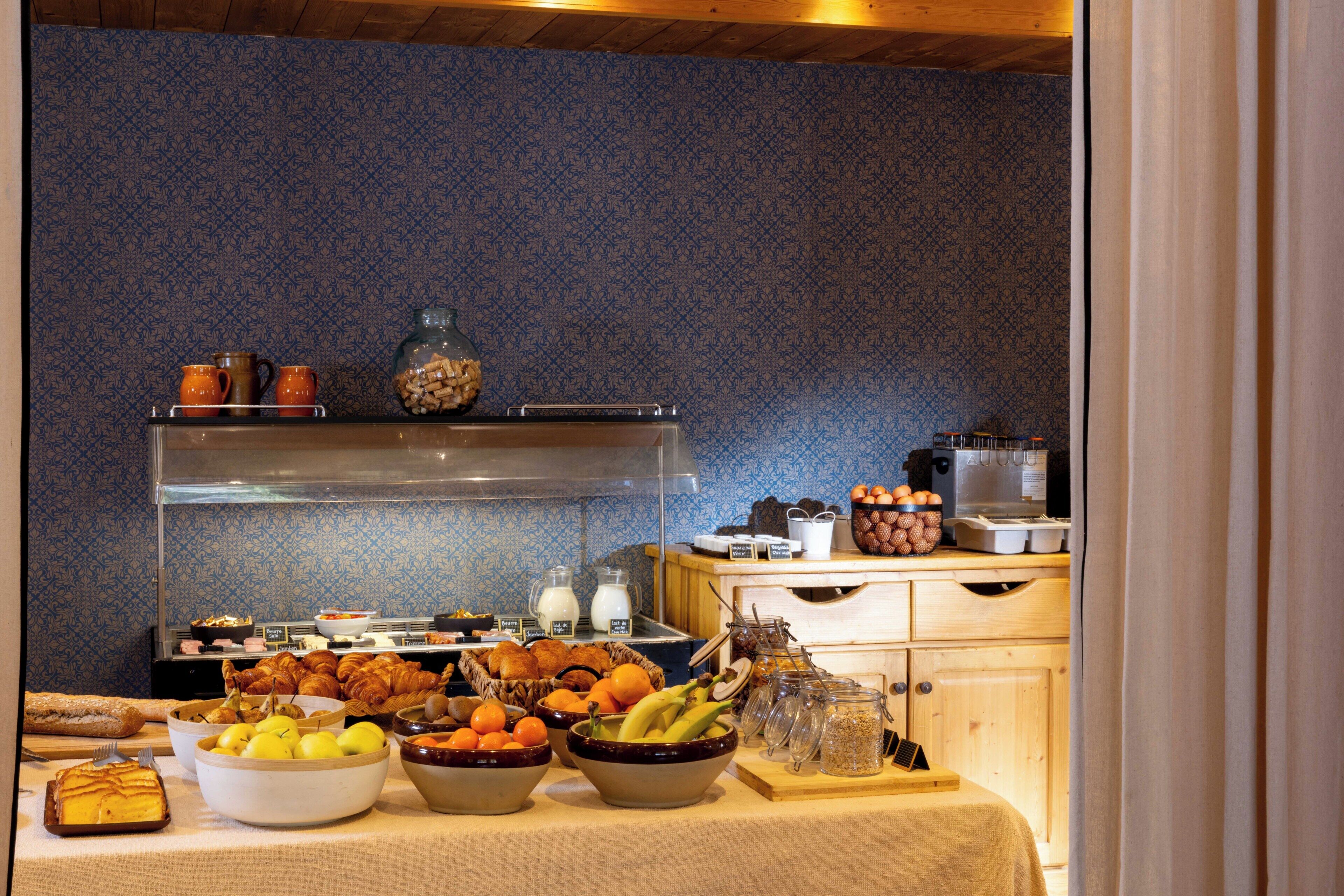 A buffet with various food items and a coffee station.