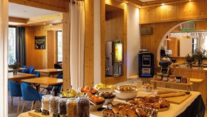 A breakfast buffet with various food items, a coffee machine, and seating arrangements. - L’Arveyron Open House (Chamonix-Mont-Blanc)