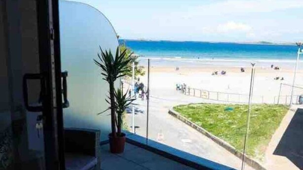 A balcony with a view of a beach and ocean. - No2 Sandy Bay , Luxury Beachfront Apartment (Portrush)