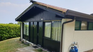 A small, single-story building with a dark exterior and a sloped roof. - Tignale / Hasewinkel (Tignale BS)