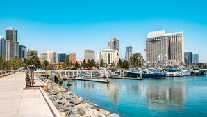 A marina with boats docked, a waterfront promenade, and a city skyline with high-rise buildings. - Canyon View Tranquil Oasis, Private Pool and Dreamy Sunsets, New Backyard (San Diego)