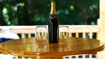 Une table en bois sur laquelle se trouvent une bouteille de champagne et deux verres.