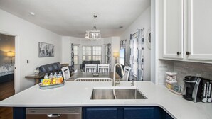 A modern kitchen with a central island, stainless steel appliances, and a coffee machine. - Legends Golf Resort Condo, 4 Beds, 2 Bath Pool access near Coastal Carolina Univ (Myrtle Beach)