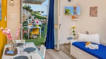 Apartment, 1 Bedroom, Smoking, Patio | Living room | TV