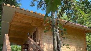 A wooden cabin with a wooden staircase leading to a door. - Holiday House Sullalbero Rural eco in Alba (Alba)