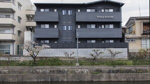 A multi-story building named Tofukuji Riverside with a modern architectural design, located beside a water body. - Tofukuji Riverside (Kyoto)
