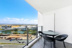 A balcony with a view of a river and cityscape, including a bridge and buildings. - Hinterland Views 2BR apartment - Sierra Grand (Broadbeach)