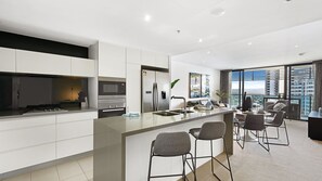 Fridge, microwave, oven, stovetop - Oracle Broadbeach Gorgeous Modern 2 Bed 1 Bath Apartment - CoastHM (Broadbeach)