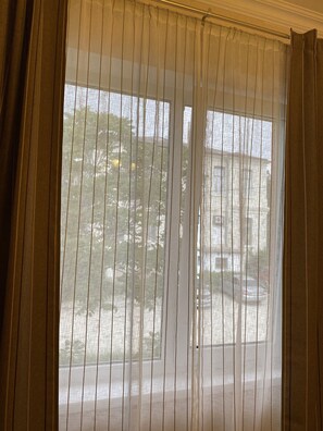 Enjoy a serene view of the surrounding neighborhood from this room's window.