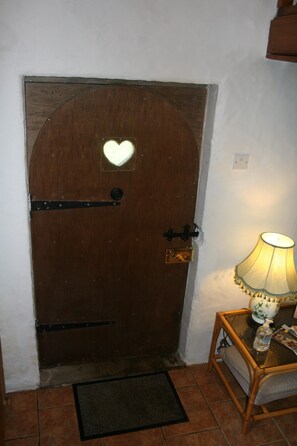 A wooden door with a heart-shaped window, a doorknob, and a latch. - Snow White's House - Farm Park Stay with Hot Tub, BBQ & Fire Pit (Swansea)