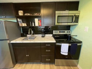 Fridge, coffee/tea maker, cookware/dishes/utensils