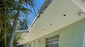 A single-story building with a light green exterior, a small window, and a door. - Sea Treasure - Only 2 blocks to the Beach (Cape Canaveral)