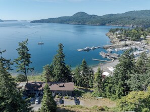 A marina with boats docked, surrounded by dense forest and hills. - Orcas Island, Rosario Hillside Retreat #278 (Orcas Island)