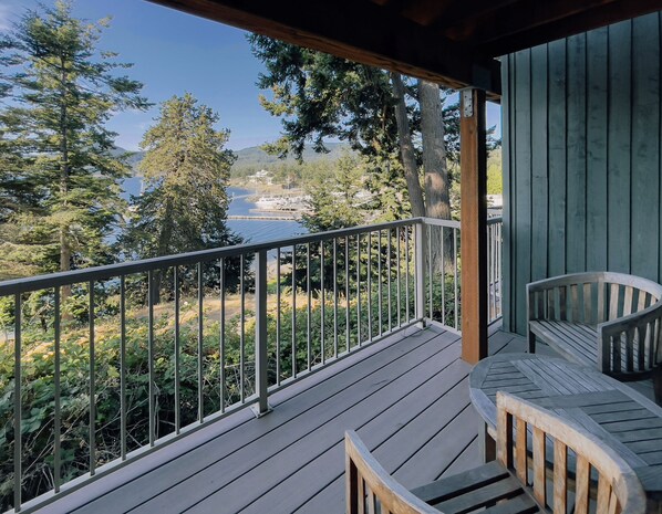 A wooden deck with a railing, overlooking a body of water and trees. - Orcas Island, Rosario Hillside Retreat #278 (Orcas Island)