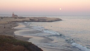 A coastal landscape with a lighthouse, beach, and ocean waves. - lower west side style & quality 1BR (Santa Cruz)