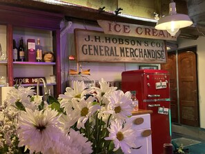 Step into the nostalgic J.H. Hobson & Co. General Merchandise, where a vintage ice cream parlor offers a selection of beverages and sweet treats.