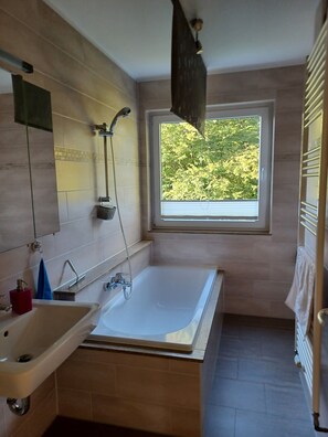 Combined shower/tub, hair dryer, towels, soap