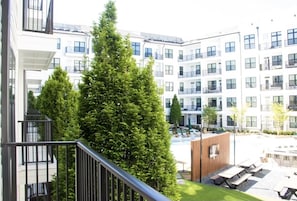 Residents can enjoy a courtyard with outdoor seating areas amidst a variety of trees.