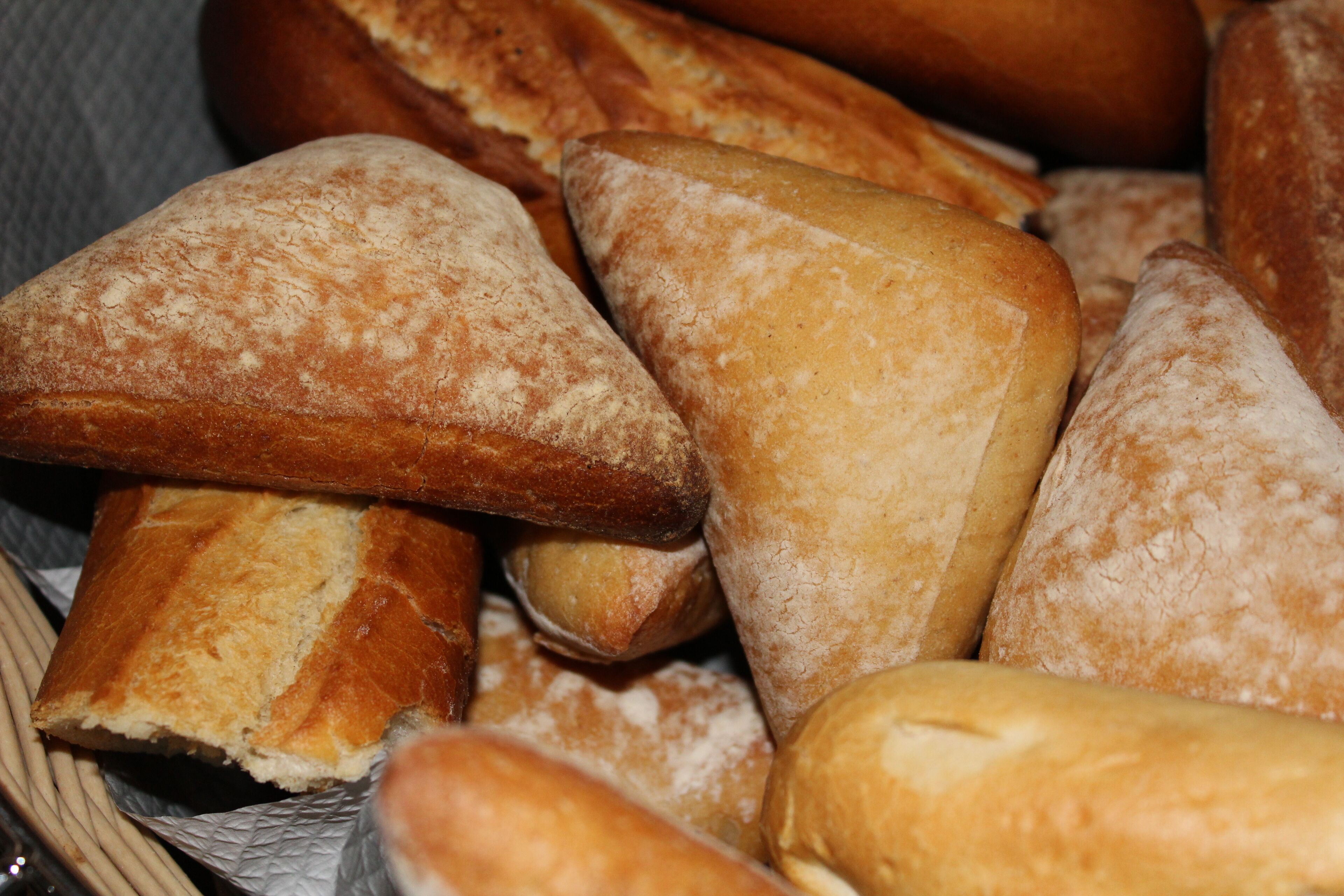 A basket filled with various types of bread.