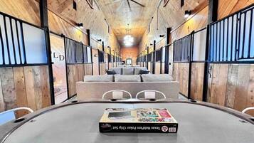 A circular room with a central table displaying a Texas Hold'em Poker Chip Set. The room has wooden walls and a ceiling fan.