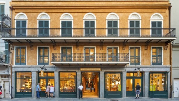 A two-story building with a ground-floor shop and upper-floor balconies.