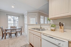 Modern kitchen with stylish basin features and appliances.