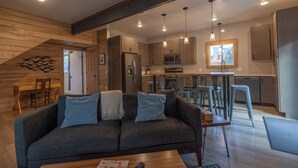 A modern kitchen with wooden cabinetry, stainless steel appliances, and pendant lighting. - Great Family Getaway on the East side of Traverse City (Traverse City)
