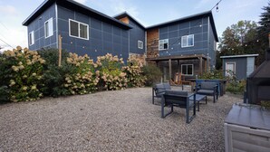 A modern two-story house with a gravel driveway and outdoor seating area. - Great Family Getaway on the East side of Traverse City (Traverse City)