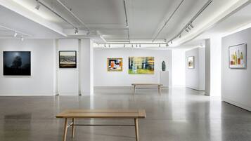 An art gallery with white walls and a polished concrete floor.