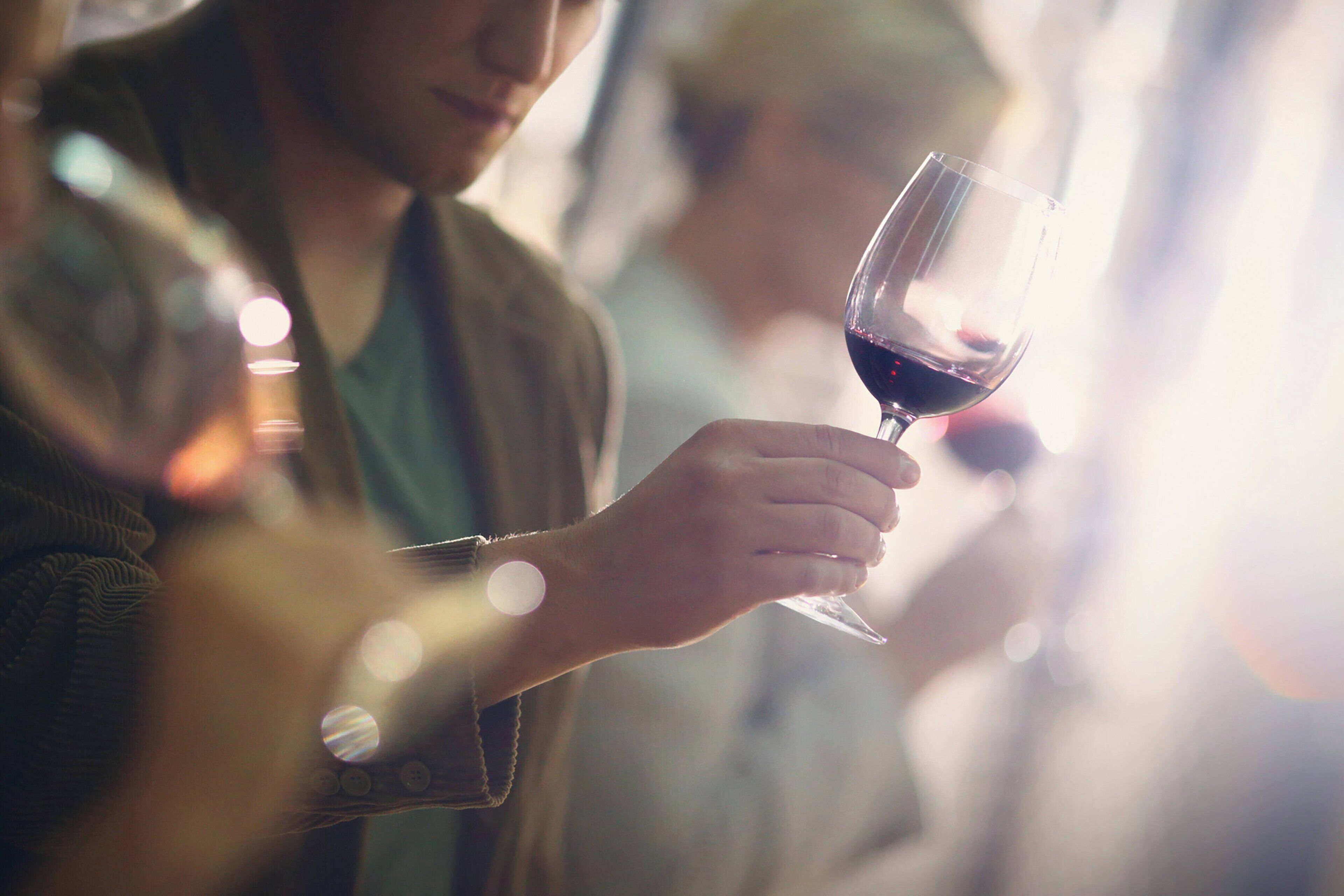 A person holding a wine glass.