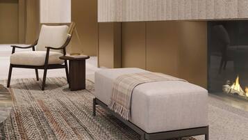 A modern room with a sofa, armchair, and a small side table.