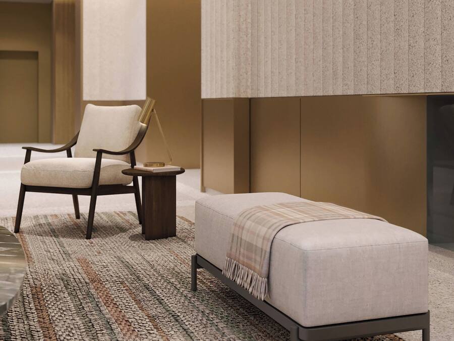 A modern room with a sofa, armchair, and a small side table.