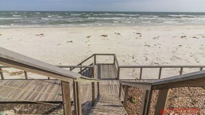 A wooden boardwalk leading to a sandy beach with ocean views. - Beautiful Remodeled Oceanfront Condo ~ Best Location and Spectacular Views! (Saint Augustine)