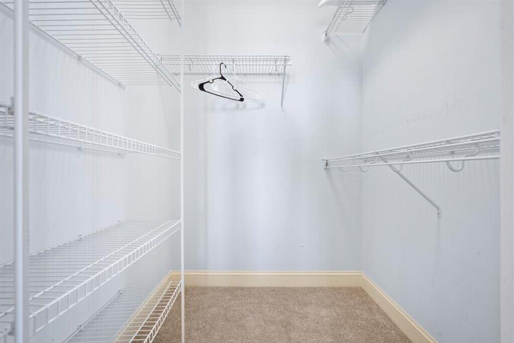 A storage room with metal shelving units and a hanging rack.