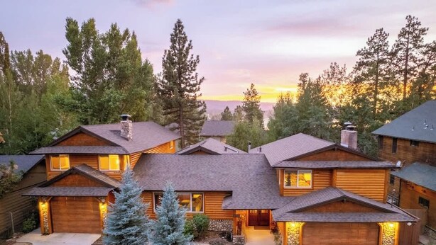 A log cabin-style building with a stone chimney, a wooden deck, and a well-maintained garden. - Big Bear Biltmore. Walk to the Park and Lake. Spa. (Big Bear Lake)