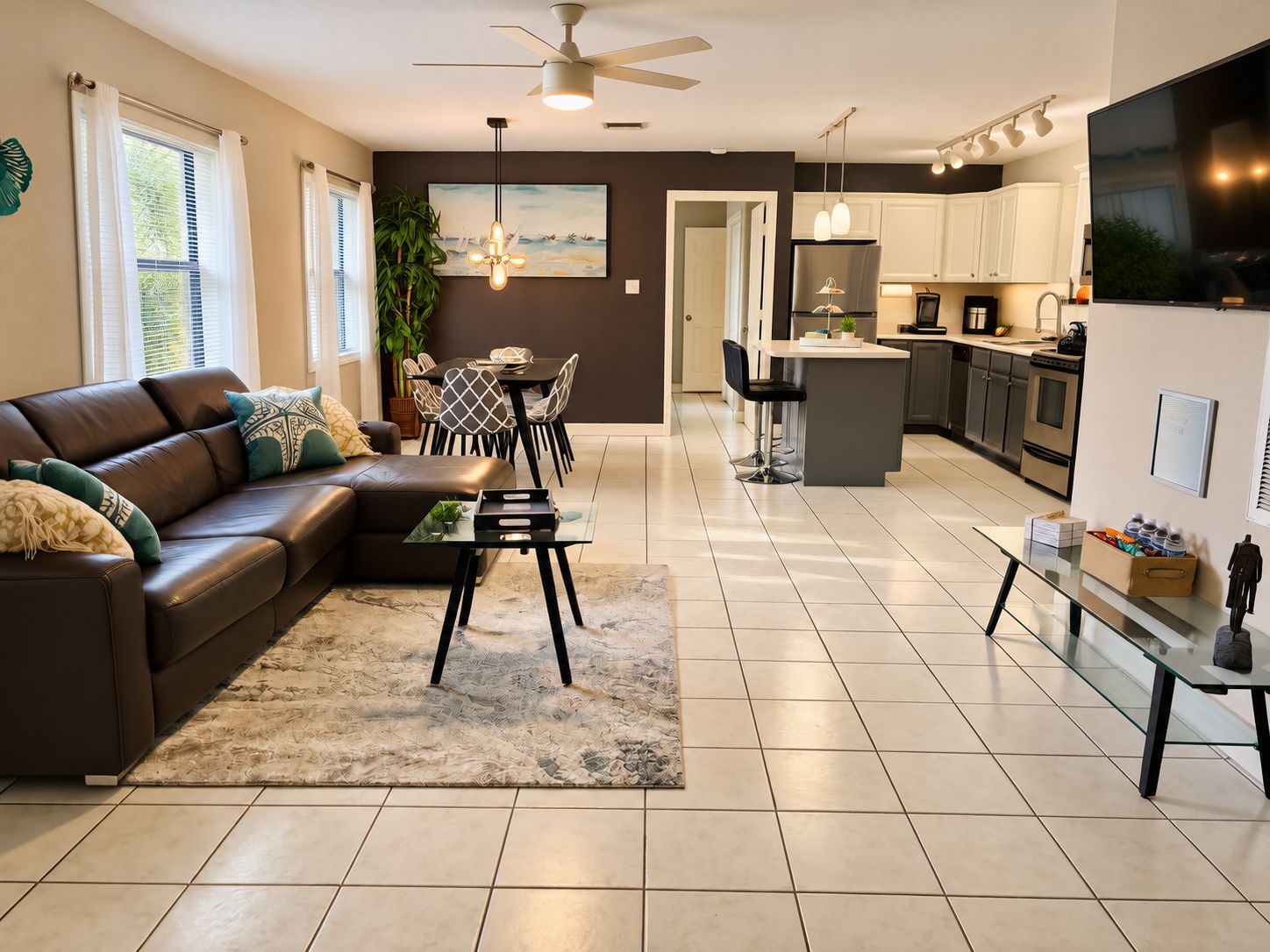 A modern living room with a sofa, coffee table, and dining area.