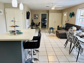 A modern living room with a dining area, a sofa, and a coffee table.