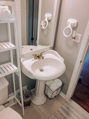 Combined shower/bathtub, towels, soap, toilet paper