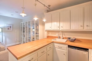 Modern kitchen with sink, dishwasher, and elegant cabinetry.