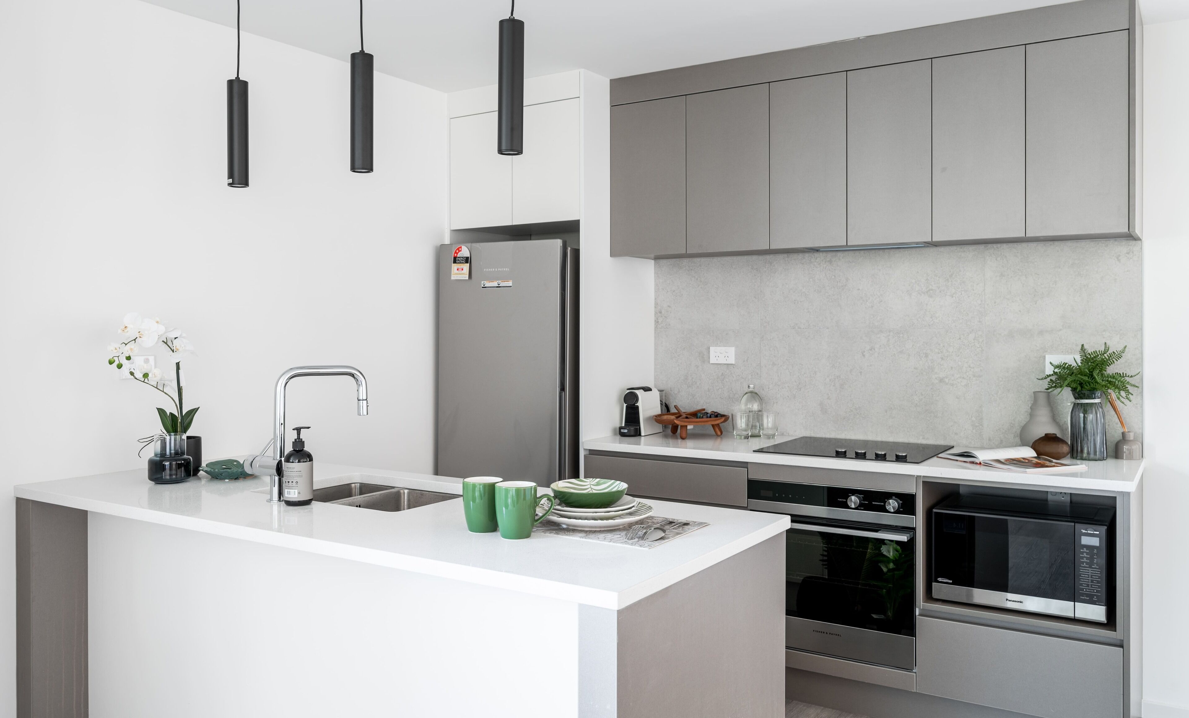 A modern kitchen with a central island, stainless steel appliances, and a minimalist design.