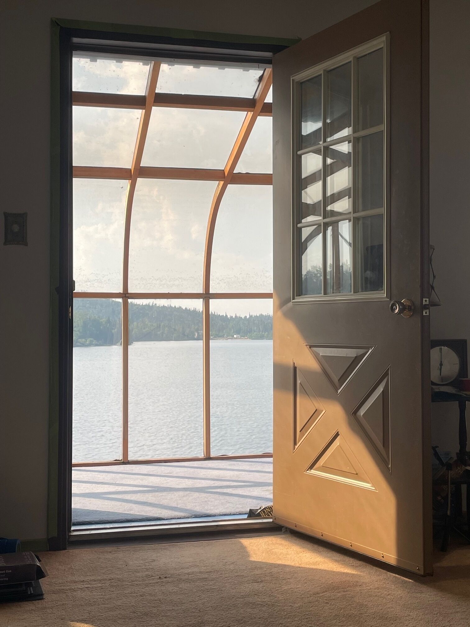 View from living room to sunroom door. With old floors.